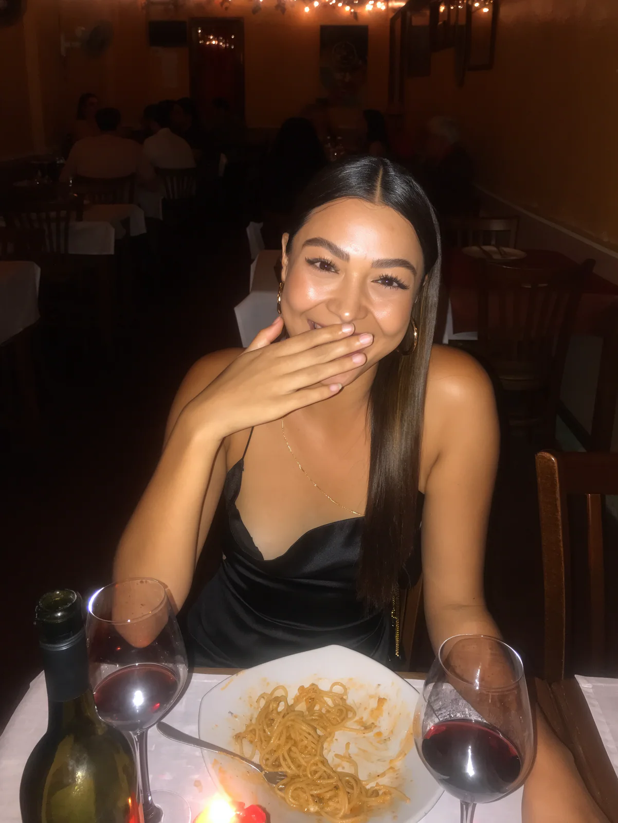 MOSS Image flash photo of a woman laughing at a candlelit dinner