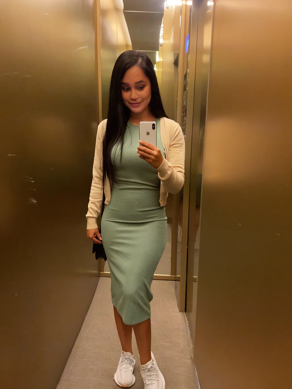 MOSS Image mirror selfie of a woman in an elevator