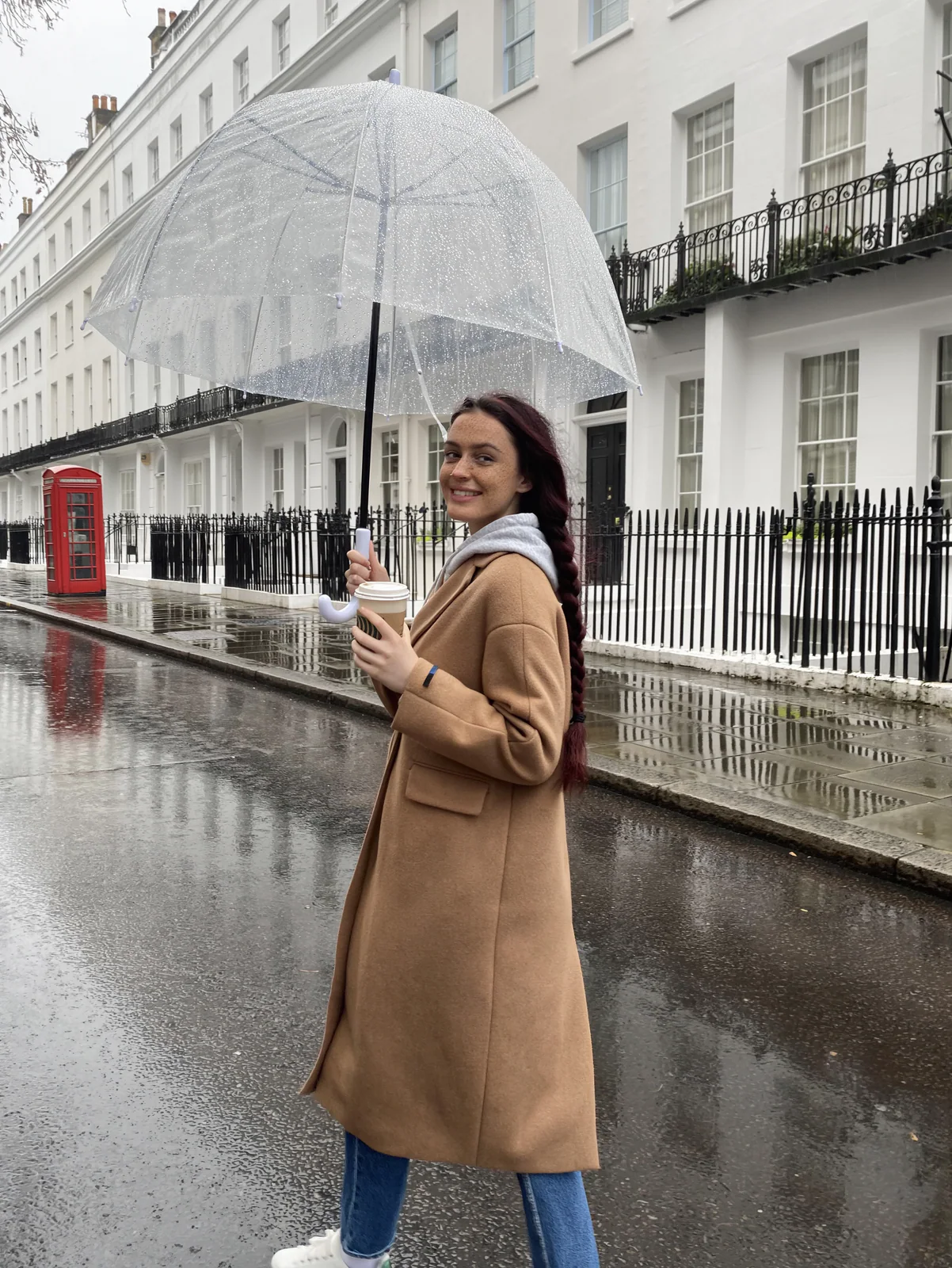 MOSS Image photo of a woman with a clear umbrella on a rainy London street