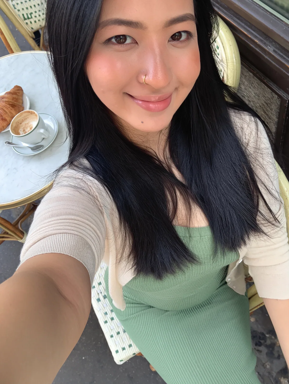 MOSS Image high-angle front-camera selfie of a woman at a cafe table