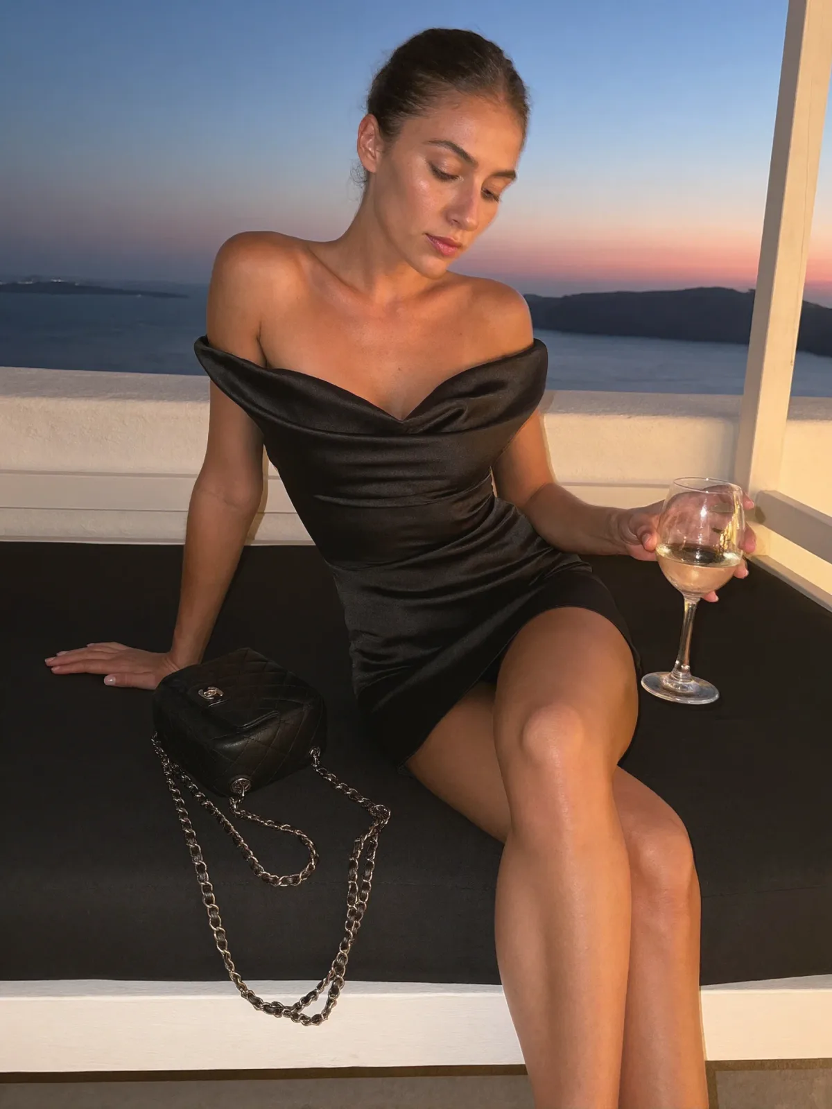 AI photo: black satin dress at sunset with white wine, made with KREA 2