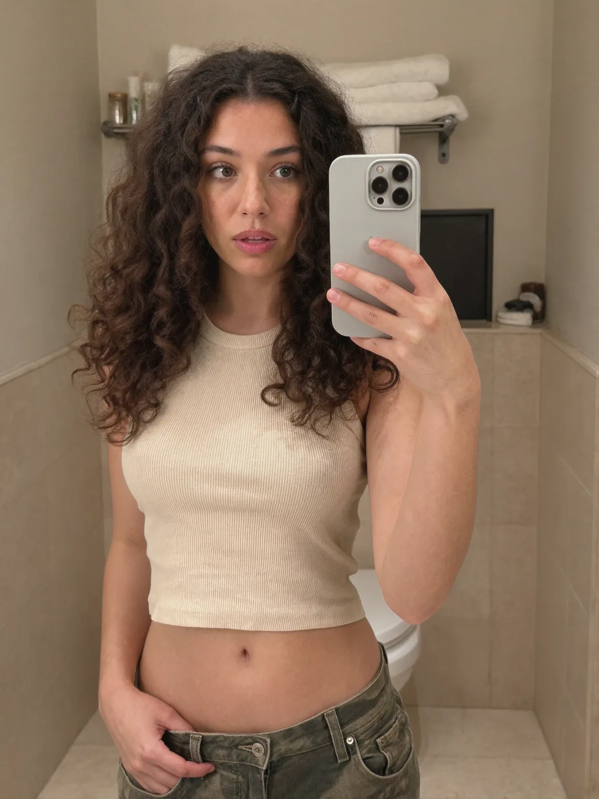 AI photo of a woman with voluminous dark brown curly hair: curly hair cream top mirror selfie, made with KREA 2