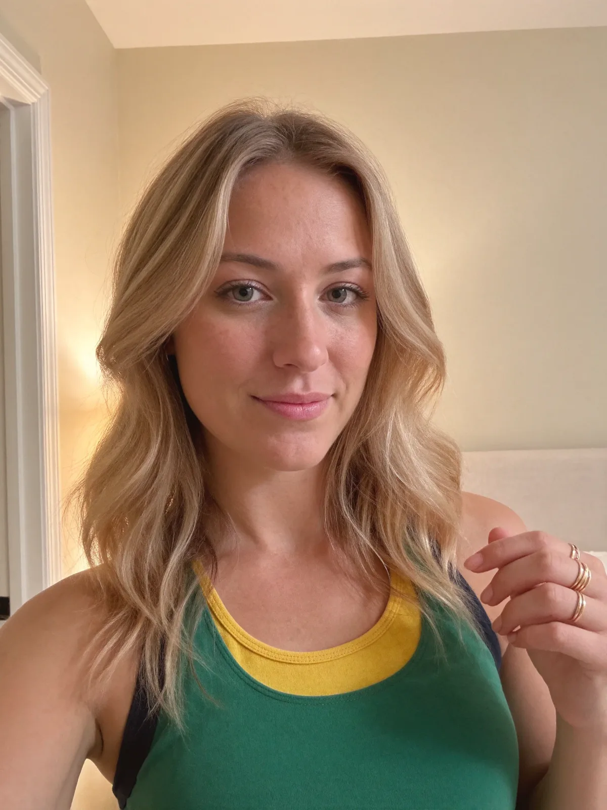 AI photo of a woman with shoulder-length wavy blonde hair: green sporty top portrait, made with KREA 2