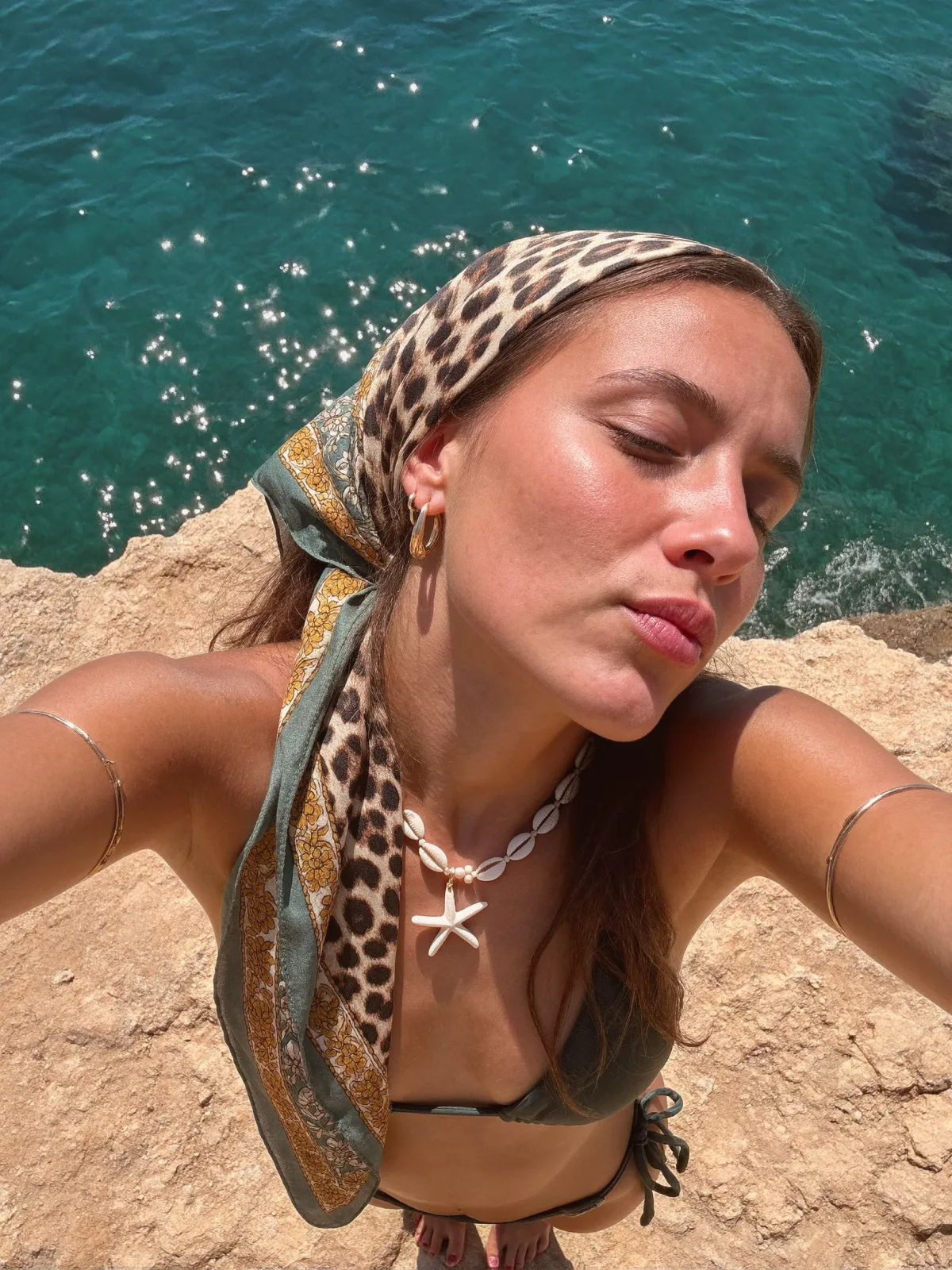 AI photo: leopard headscarf cliffside selfie, made with KREA 2