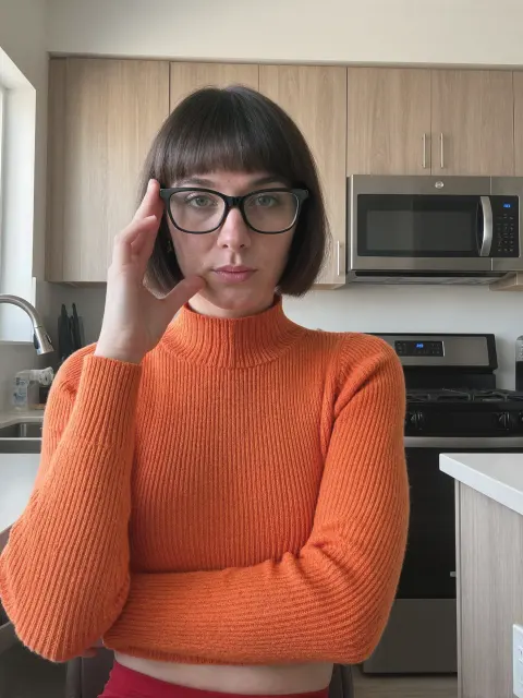 AI photo: orange sweater and glasses kitchen selfie, made with KREA 2