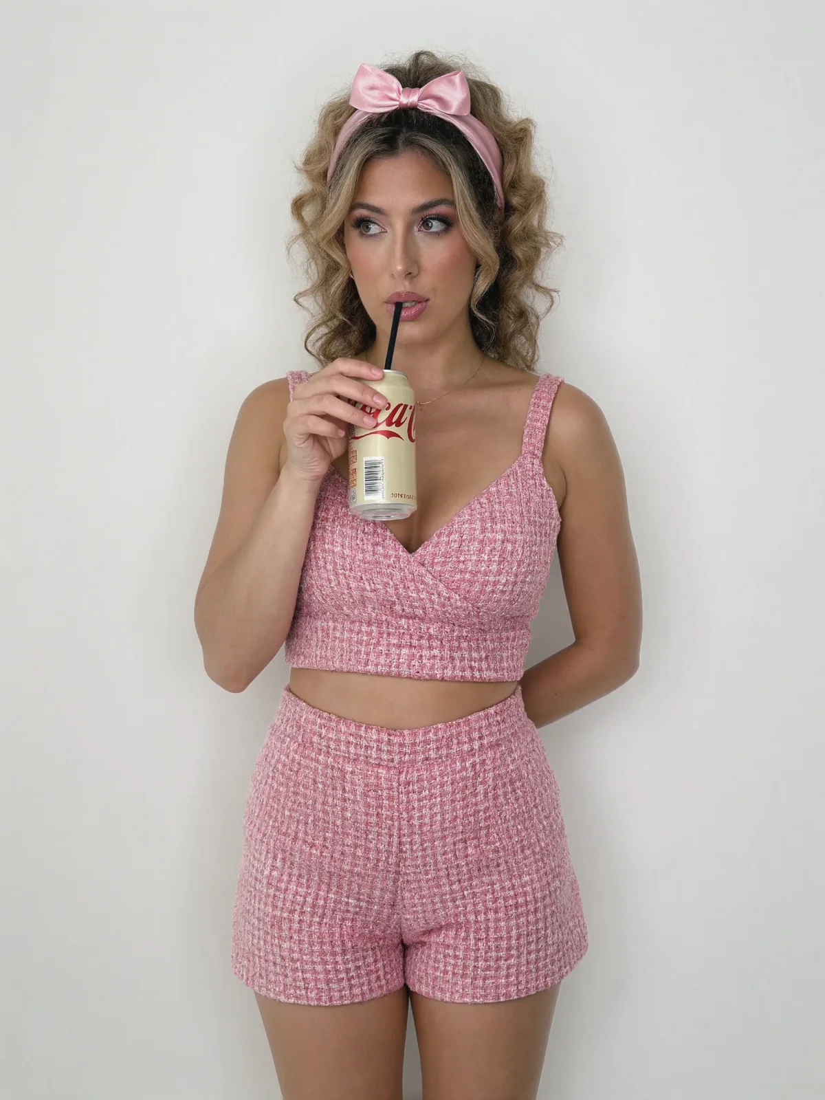 AI photo: pink tweed set sipping a soda, made with KREA 2