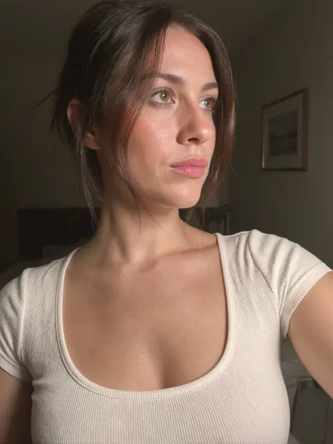 AI photo of a woman with long dark brown hair: white tee close-up portrait, made with KREA 2